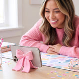 Sitting Pretty Bow Phone Stand

Why settle for a boring stand when you can have your phone Sitting Pretty? Fred’s coquette-inspired phone stand features a cute bow design that’s pretty, pink, and perfectly poised for scrolling, streaming, and staying hands-free. Made from soft-touch rubber, it’s equally fashionable as it is functional.

Measures 2.6" x 2.4" x 2.4"&nbsp;
Design by Winsor Pop, Fred Studio.