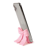 Sitting Pretty Bow Phone Stand

Why settle for a boring stand when you can have your phone Sitting Pretty? Fred’s coquette-inspired phone stand features a cute bow design that’s pretty, pink, and perfectly poised for scrolling, streaming, and staying hands-free. Made from soft-touch rubber, it’s equally fashionable as it is functional.

Measures 2.6" x 2.4" x 2.4"&nbsp;
Design by Winsor Pop, Fred Studio.
