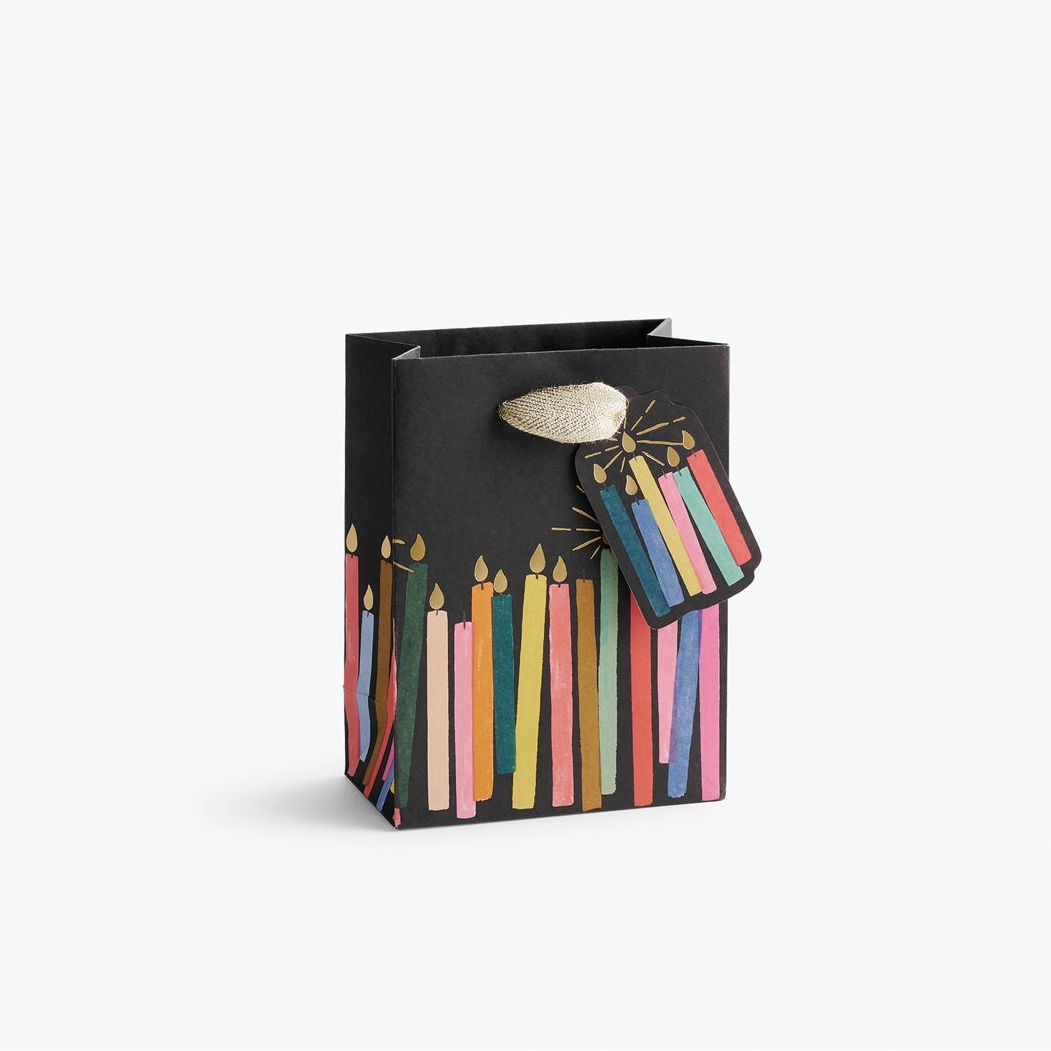 Giving gets even more special with our gift bags, which feature charming extras like gold foil accents, cotton ribbon handles, and a coordinating “To” and “From” tag.

Small: 6 x 4.5 x 0.3 in
Coated paper with cotton ribbon handles
Printed in full color and UV gold glitter
Gold lurex ribbon handles