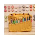 Your art is bold. Your bag should be too. The world's most loved art supply bag, pottery tool bag &amp; knitting project bag – backed by over 10,000 global artists!

✌️ 15 stunning colors ✌️

🌈 Over 30 Pockets Of Varying Sizes

🌈 Slanted Skinny Pockets : For your most-loved tools that beg for your attention (carving tools, knitting needles, crochet hooks

🌈&nbsp;Large Interior Storage + 2 interior pockets: Perfect for carrying glazes, knitting yarn, crochet supplies, and craft supplies

🌈 Phone &amp; Wa