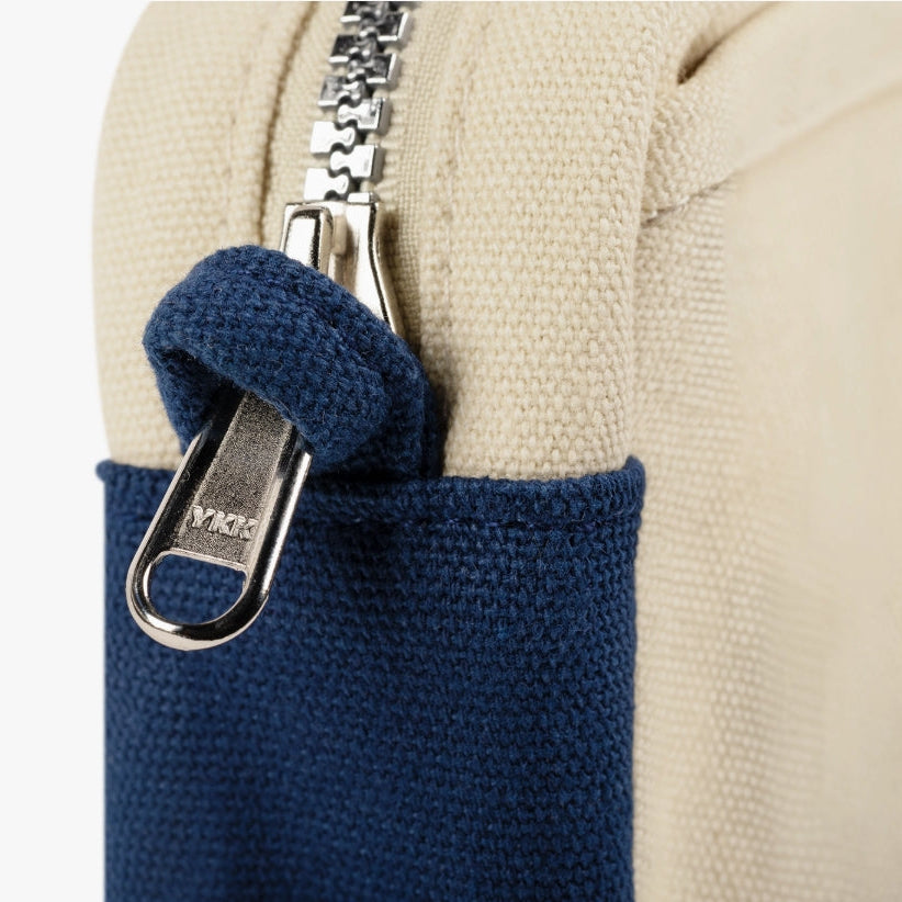 A compact carry-all pouch for artists, makers, and stationary lovers who appreciate a little order in their chaos. Structured enough to hold its form, soft enough to fit anywhere, and fully machine-washable for the days that get a little messy — your tools, pens, and creative essentials stay safe, visible, and ready wherever you go.

Inside, 20 pockets make space for art supplies, stationary essentials, and an A5 notebook, all secured by a smooth YKK zipper. Sized to fit within larger bags or carry on its o