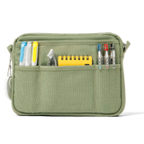 A compact carry-all pouch for artists, makers, and stationary lovers who appreciate a little order in their chaos. Structured enough to hold its form, soft enough to fit anywhere, and fully machine-washable for the days that get a little messy — your tools, pens, and creative essentials stay safe, visible, and ready wherever you go.

Inside, 20 pockets make space for art supplies, stationary essentials, and an A5 notebook, all secured by a smooth YKK zipper. Sized to fit within larger bags or carry on its o