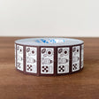 Stamp Marche Label Sticker Roll - Cookie Tin Brown Roll of decorative tape with a pattern on a wooden surface
