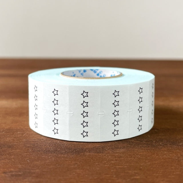Stamp Marche Planner Label Sticker Roll - 5 Star Rating Roll of tape with star pattern on a wooden surface