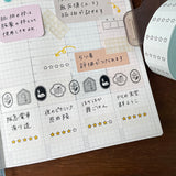 Notebook page with stickers and text on a wooden surface