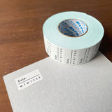 Stamp Marche Planner Label Sticker Roll - Date and Days of the Week Roll of tape with labels on a wooden surface