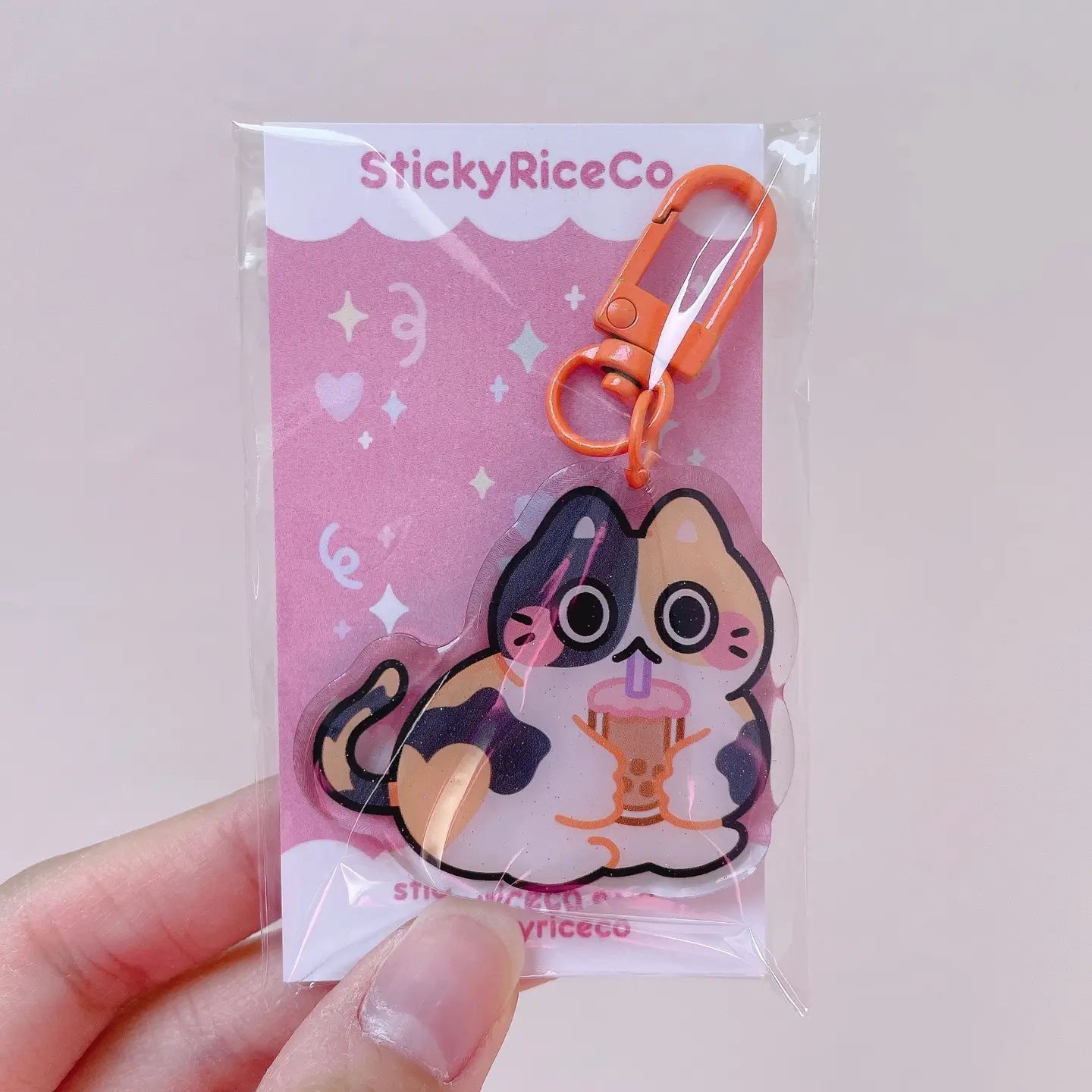 StickyRiceCo Boba Calico Cat Glitter Keychain

This boba drinking cat keychain&nbsp;is the perfect accessory to your phone, purse, backpack, etc!

PLEASE NOTE: There may be plastic film covers on the backs of the keychains. The film is there to protect the keychains in transit and may look scratched. They can be removed to show shine/clarity on the surface.

Details:

2" in wide&nbsp;
ONE SIDED glitter epoxy with flat back&nbsp;
Double sided printing on sturdy acrylic&nbsp;
Colors may differ from picture du