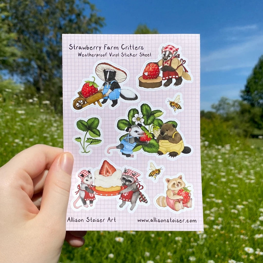 This A6-sized sticker sheet features a group of woodland creatures who grow, harvest, and bake with strawberries! From the opossum and beaver who tend the plants to the skunk who harvests them, from the badger who bakes the cake to the opossum and raccoon who serve it, everyone contributes, even the little blonde raccoon who's just enjoying a juicy strawberry snack!