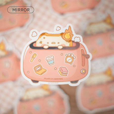 A sticker of burnt Muffinmaru toast feeling burnt out first thing in the morning. This sticker has a shiny mirror-like finish on some parts of the toaster for some extra flare. This durable sticker is great for decorating water bottles, laptops, suitcases, and much more!

Dimensions: 2.8" x 2.5" (7.1cm x 6.4cm)
Material: PET
Waterproof
Quantity: 1 sticker