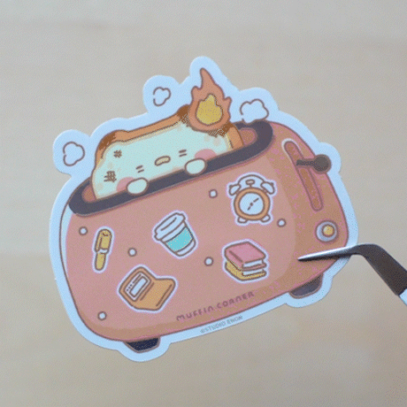 A sticker of burnt Muffinmaru toast feeling burnt out first thing in the morning. This sticker has a shiny mirror-like finish on some parts of the toaster for some extra flare. This durable sticker is great for decorating water bottles, laptops, suitcases, and much more!

Dimensions: 2.8" x 2.5" (7.1cm x 6.4cm)
Material: PET
Waterproof
Quantity: 1 sticker