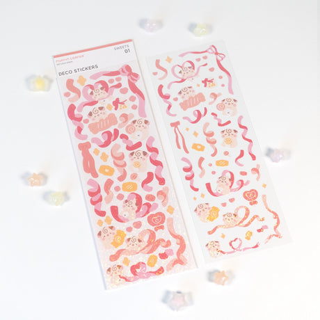 The Cocoroll Sweets deco sticker sheet features Cocoroll surrounded by adorable candies. Available in pink and purple versions, these cute deco stickers are the perfect addition to any polaroids/toploaders, journals, and more. The sparkly holo overlay adds an extra touch of shine and magic.

Dimensions: 2.7” x 8" (6.8cm x 20.5cm)
Quantity: 1 sheet