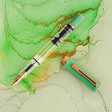 TWSBI ECO Jade Jelly w/ Bronze Fountain Pen

The Jade Jelly TWSBI eco features a lovely milky looking green that nicely matches its name. The jade coloring is offset with polished bronze trim and nib. Its piston-filling system and smooth steel nib deliver a consistent, enjoyable writing experience for journaling, note‑taking, and everyday use.

Featuring a cream-and-clear resin body with bronze trim, this pen’s transparent barrel lets you monitor ink levels while showcasing TWSBI’s precision piston mechanis