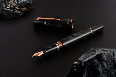 This TWSBI Obsidian fountain pen is made of a dark grey/black swirled acrylic resin, inspired by the natural obsidian stone. The pen is complemented by rose gold-plated trim and is equipped with a rose gold-plated stainless-steel nib.

Pen cap is&nbsp;able to post&nbsp;onto the back of the pen

Piston Filler Fountain pen.
Simply unscrew the end cap, dip into ink, screw back the end cap, and you're done! Ready to write!!