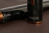 This TWSBI Obsidian fountain pen is made of a dark grey/black swirled acrylic resin, inspired by the natural obsidian stone. The pen is complemented by rose gold-plated trim and is equipped with a rose gold-plated stainless-steel nib.

Pen cap is&nbsp;able to post&nbsp;onto the back of the pen

Piston Filler Fountain pen.
Simply unscrew the end cap, dip into ink, screw back the end cap, and you're done! Ready to write!!
