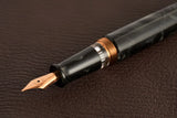 This TWSBI Obsidian fountain pen is made of a dark grey/black swirled acrylic resin, inspired by the natural obsidian stone. The pen is complemented by rose gold-plated trim and is equipped with a rose gold-plated stainless-steel nib.

Pen cap is&nbsp;able to post&nbsp;onto the back of the pen

Piston Filler Fountain pen.
Simply unscrew the end cap, dip into ink, screw back the end cap, and you're done! Ready to write!!