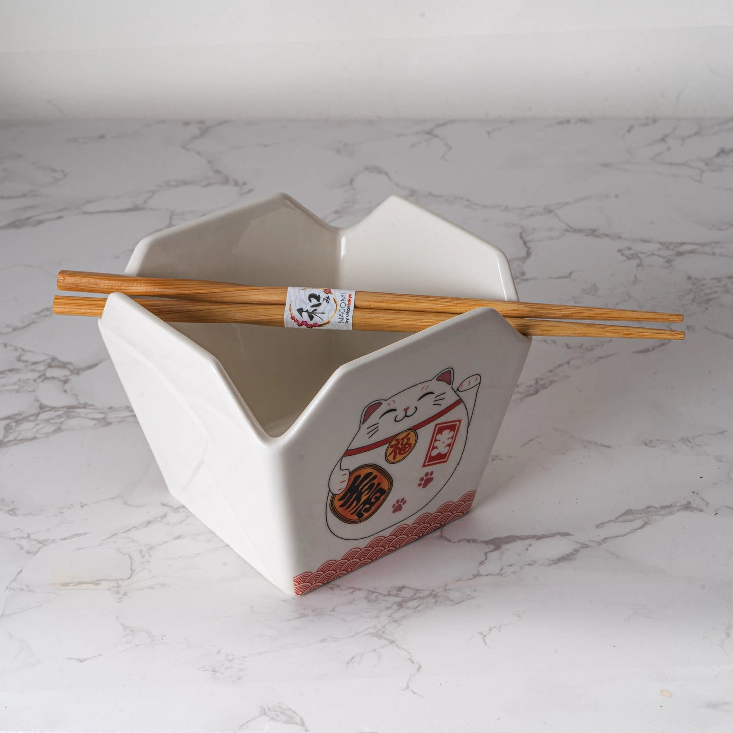 Everything tastes better in a to-go container…but this one is designed to be reusable

Bowl Size: 5" Dia x 4"H
Chopsticks 9"L
Capacity: 16 fl oz
Material: Ceramic
Microwave and Dishwasher Safe
Origin: China