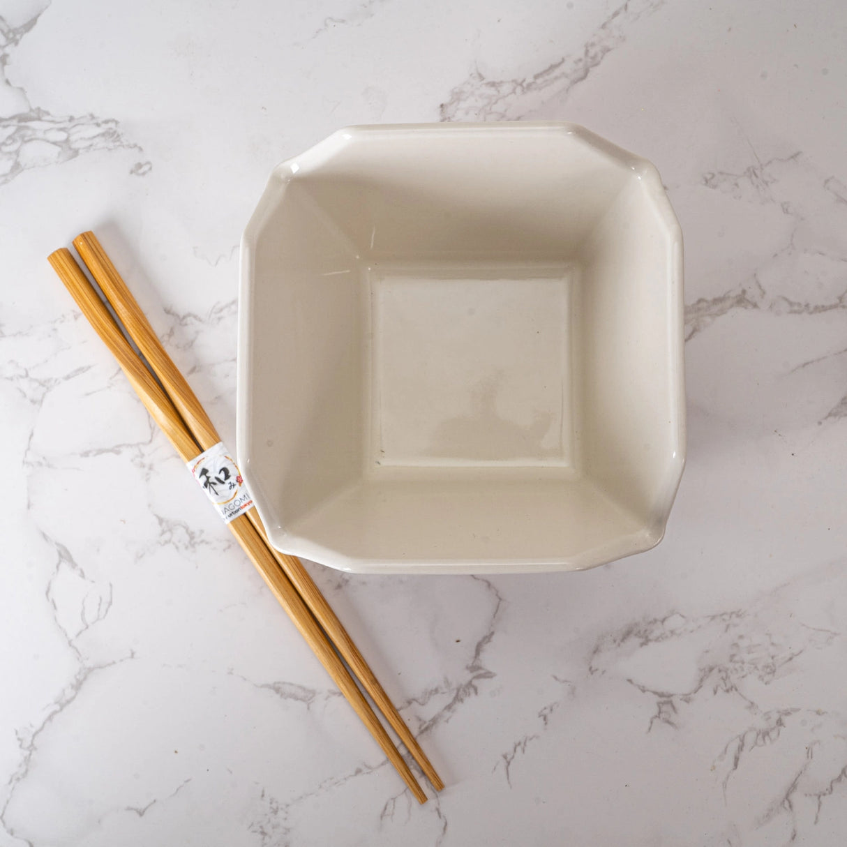 Everything tastes better in a to-go container…but this one is designed to be reusable

Bowl Size: 5" Dia x 4"H
Chopsticks 9"L
Capacity: 16 fl oz
Material: Ceramic
Microwave and Dishwasher Safe
Origin: China
