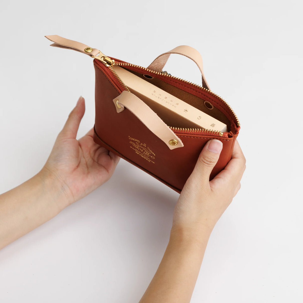 We made a miniature version of our engineer bag as a key case,and somehow, this one turned out a little bigger.

Still, the plump, playful leather pouch is fun to carry and somehow even looks delicious.

It’s sized to fit a paperback or an A6 notebook.

Size: W19.5×H12.5×D4.5cm
About the Leather – Japanese Glove Leather

Made from durable and supple Japanese glove leather, known for its lightness and strength.

Originally used for baseball gloves, this leather is highly resistant to friction and becomes sof