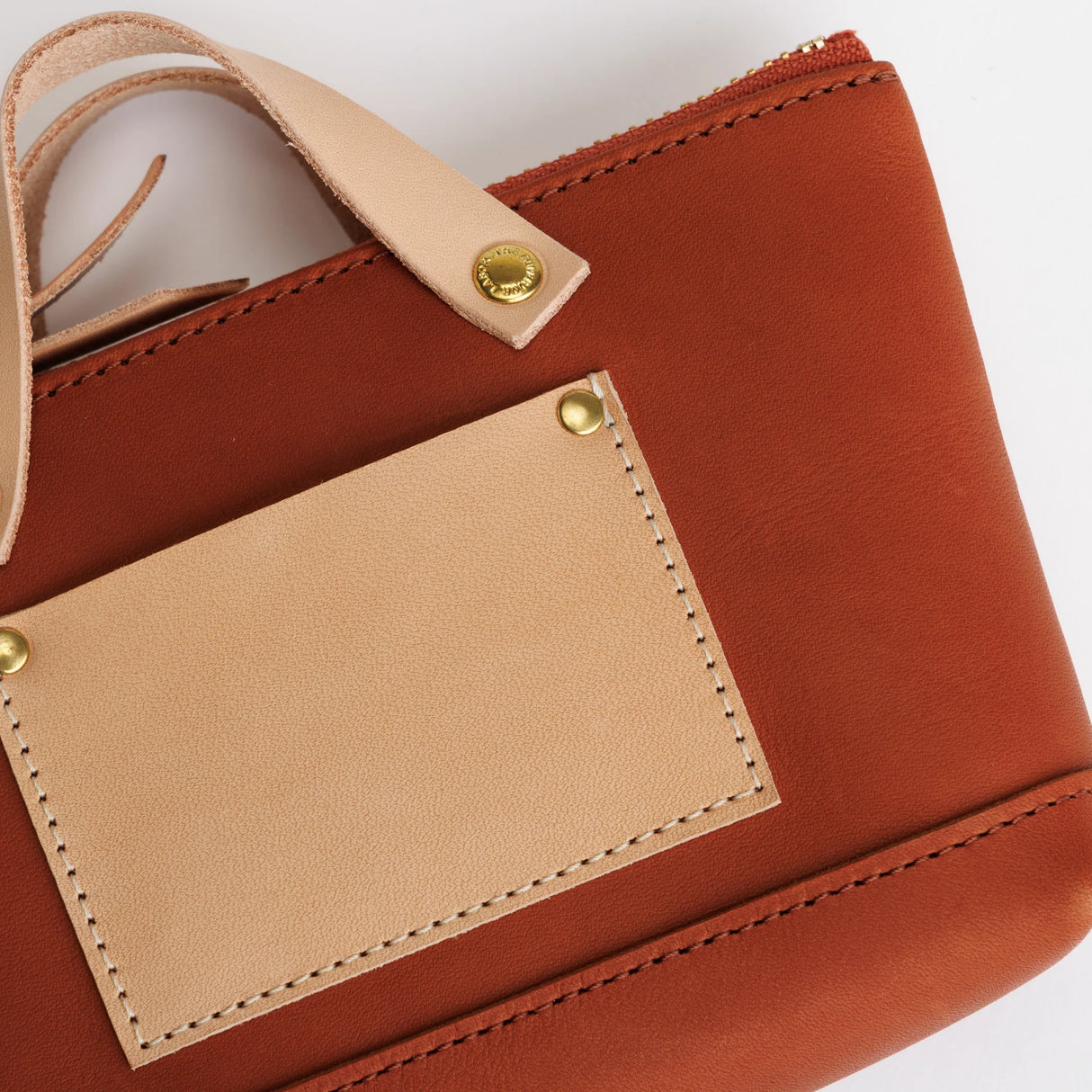 We made a miniature version of our engineer bag as a key case,and somehow, this one turned out a little bigger.

Still, the plump, playful leather pouch is fun to carry and somehow even looks delicious.

It’s sized to fit a paperback or an A6 notebook.

Size: W19.5×H12.5×D4.5cm
About the Leather – Japanese Glove Leather

Made from durable and supple Japanese glove leather, known for its lightness and strength.

Originally used for baseball gloves, this leather is highly resistant to friction and becomes sof