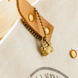 Brass charm in the shape of an engineer tote bag.

Equipped with a sleek ball chain, it attaches effortlessly to your bags, pouches, or key rings. Despite its petite size, it brings the distinct, rich texture and unmistakable presence that only genuine brass can provide.

As you use it, the brass will develop a natural patina over time—enjoy the changing character that comes with age.

Color: The color you see on your screen may differ from the actual product.

Brass Products

Due to the nature of brass, so