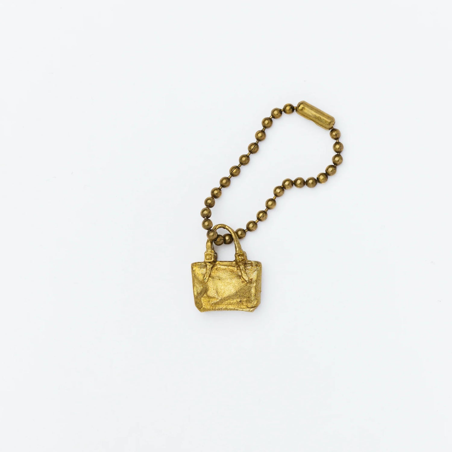 Brass charm in the shape of an engineer tote bag.

Equipped with a sleek ball chain, it attaches effortlessly to your bags, pouches, or key rings. Despite its petite size, it brings the distinct, rich texture and unmistakable presence that only genuine brass can provide.

As you use it, the brass will develop a natural patina over time—enjoy the changing character that comes with age.

Color: The color you see on your screen may differ from the actual product.

Brass Products

Due to the nature of brass, so