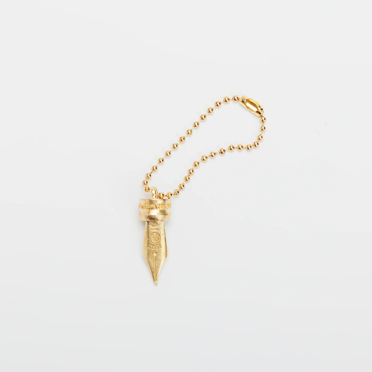 A Fountain Pen Nib Charm: Carried with Meaning

A solid brass charm meticulously shaped in the likeness of a classic fountain pen nib. Every intricate detail is beautifully captured, complete with the inspiring engraved message, "The Pens Will Be With You Always."

Equipped with a sleek ball chain, it attaches effortlessly to your bags, pouches, or key rings. Despite its petite size, it brings the distinct, rich texture and unmistakable presence that only genuine brass can provide.

As you use it, the brass
