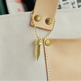 A Fountain Pen Nib Charm: Carried with Meaning

A solid brass charm meticulously shaped in the likeness of a classic fountain pen nib. Every intricate detail is beautifully captured, complete with the inspiring engraved message, "The Pens Will Be With You Always."

Equipped with a sleek ball chain, it attaches effortlessly to your bags, pouches, or key rings. Despite its petite size, it brings the distinct, rich texture and unmistakable presence that only genuine brass can provide.

As you use it, the brass