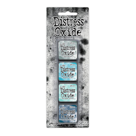 Tim Holtz Distress Mini Oxide Ink Pads are a collection of 1 x 1 cubes featuring water-reactive dye &  pigment ink fusion that creates an oxidized effect when sprayed with water.