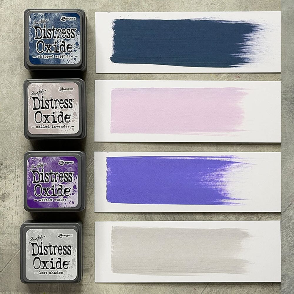 Tim Holtz Distress Mini Oxide Ink Pads are a collection of 1 x 1 cubes featuring water-reactive dye &  pigment ink fusion that creates an oxidized effect when sprayed with water.