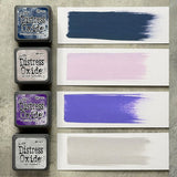 Tim Holtz Distress Mini Oxide Ink Pads are a collection of 1 x 1 cubes featuring water-reactive dye &  pigment ink fusion that creates an oxidized effect when sprayed with water.