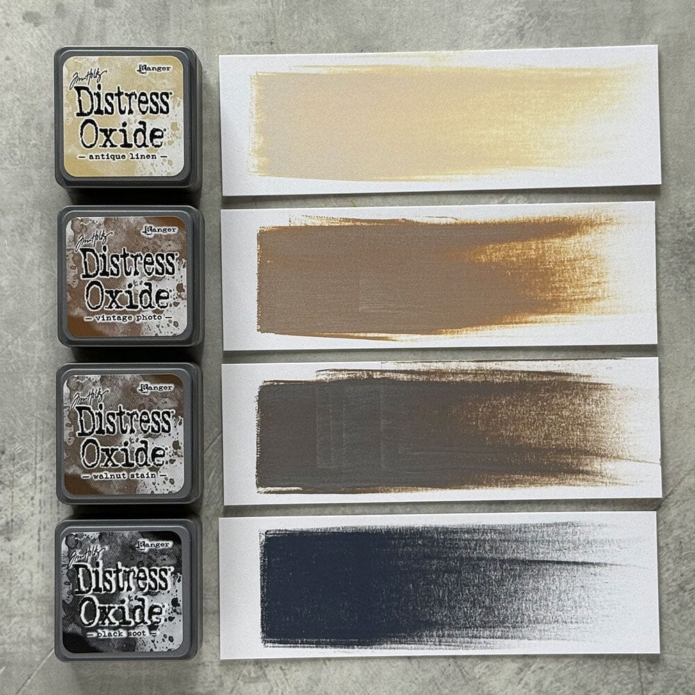 Tim Holtz Distress Mini Oxide Ink Pads are a collection of 1 x 1 cubes featuring water-reactive dye & pigment ink fusion that creates an oxidized effect when sprayed with water.