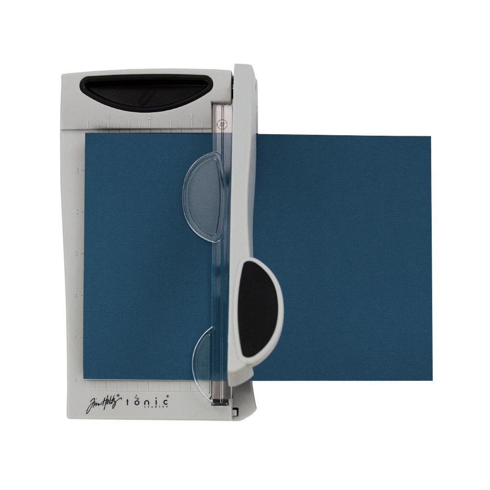 The Tim Holtz 6.25 inch / 16cm Mini Trimmer has many features not found in similar products. This product is portable and lightweight. It is perfect for trimming photographs and creating card fronts.

Features include: Hardened steel precision ground blade, Molded in measuring grid, 6.25 inch / 16cm cutting blade length and Finger guard that holds your paper in position for the perfect cut.

Width &nbsp; &nbsp;5.4 in &nbsp; &nbsp;/ &nbsp; &nbsp;13.72 cm
Height &nbsp; &nbsp;1.7 in &nbsp; &nbsp;/ &nbsp; &nbsp