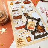 🐰🧣 Resting in their seats all cute and cozy, you'll find these fluffy winter bunbuns by @catsoul_draws in their comfy outfits, savoring their fave drinks. Now you can add a special touch of wintertime charm to your pages with these lounging toasty bunnies that are a whole mood.

Art by: @catsoul_draws

Top Coating: Gold foil

Adhesive Layer: PVC (plastic)

Backing Layer: Paper

6.69" x 3.54".

1 sheet included