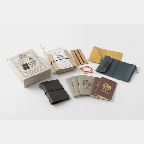 To commemorate this 20th anniversary, we’ve created a new size of TRAVELER’S notebook.

It is TRAVELER’S notebook Card Size. This TRAVELER’S notebook is always with you, even in your daily life. Whether it’s a sudden idea, information you learned or overheard, or something important you don’t want to forget— whenever and wherever you feel like writing, you can quickly grab the notebook and jot it down.

This set includes TRAVELER’S notebook Card Size, Refill Notebooks, Cotton Zipper Case, Kraft Paper Folder