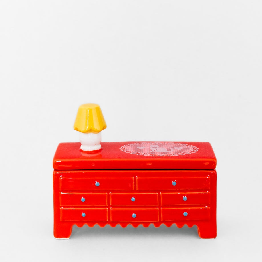 Put your trinkets in this tiny dresser with this tiny little lamp on top. You’ll feel like a doll in the tiniest little doll house. Trust us, we’ve tried it. Highly recommend.&nbsp;
