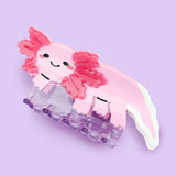 Axolotl Hair Claw' Hair Accessory by Turtle's Soup.

Includes one (1) hair claw
Claw is roughly 3"
3D, engraved, printed, and painted details
High quality acetate material, stronger than standard hair clips
Themed packaging