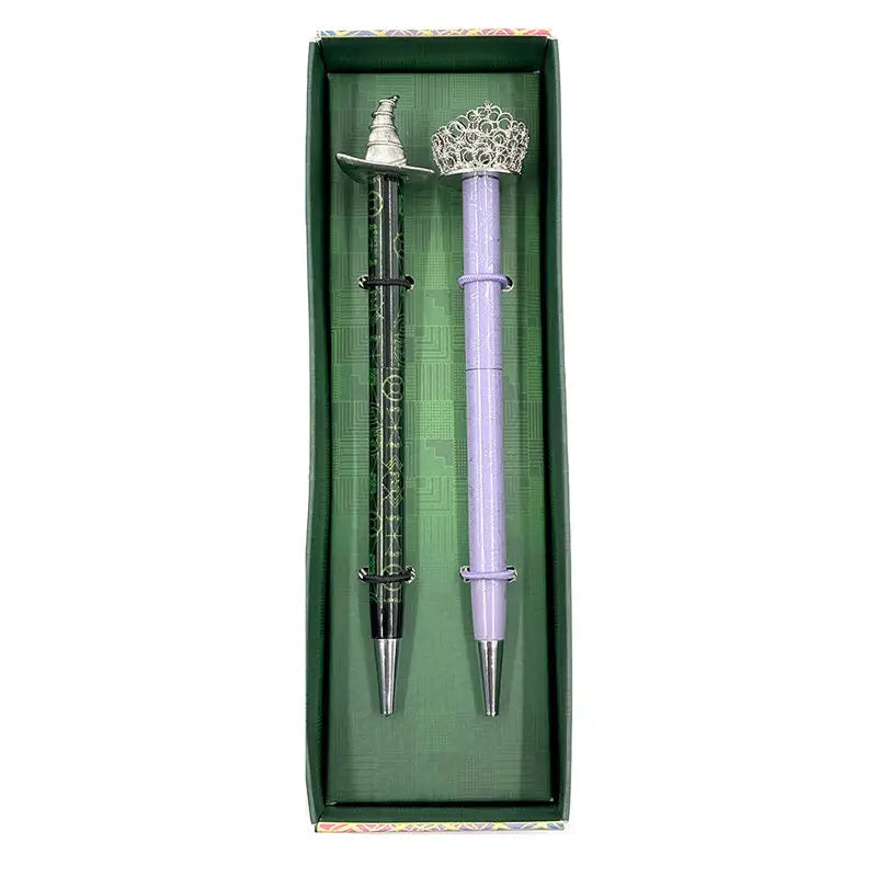 Celebrate your love of Wicked with this set of two ballpoint pens, perfect to use for writing notes, spells, or letters home from your time at Shiz University.

DETAILED DESIGN: This deluxe set contains two ballpoint pens with designs inspired by both Elphaba and Glinda. Each pen features a detailed silver, die-cast metal topper of Elphaba hat and Glinda’s crown.&nbsp;

PERFECT FOR FANS: This pen set makes a wonderful gift and is a perfect way to show your love for Wicked and the beloved characters of Elpha