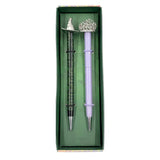Celebrate your love of Wicked with this set of two ballpoint pens, perfect to use for writing notes, spells, or letters home from your time at Shiz University.

DETAILED DESIGN: This deluxe set contains two ballpoint pens with designs inspired by both Elphaba and Glinda. Each pen features a detailed silver, die-cast metal topper of Elphaba hat and Glinda’s crown.&nbsp;

PERFECT FOR FANS: This pen set makes a wonderful gift and is a perfect way to show your love for Wicked and the beloved characters of Elpha