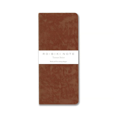 The RO‑BIKI Note is a beautifully crafted Japanese notebook known for its distinctive waxed paper cover, which gains character the more you use it. Over time, the cover softens, develops a natural patina, and becomes uniquely yours—making every notebook feel personal and well‑loved.

Inside, you’ll find high‑quality blank paper ideal for writing, sketching, planning, or journaling. Its compact size makes it perfect for everyday carry, while the durable construction ensures it holds up to frequent use.

Thes