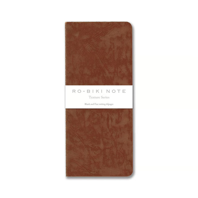 The RO‑BIKI Note is a beautifully crafted Japanese notebook known for its distinctive waxed paper cover, which gains character the more you use it. Over time, the cover softens, develops a natural patina, and becomes uniquely yours—making every notebook feel personal and well‑loved.

Inside, you’ll find high‑quality blank paper ideal for writing, sketching, planning, or journaling. Its compact size makes it perfect for everyday carry, while the durable construction ensures it holds up to frequent use.

Thes