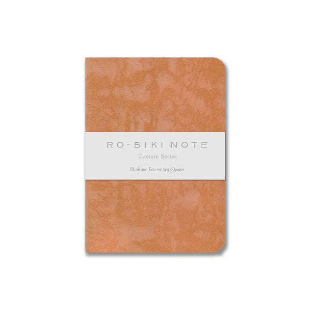 The RO‑BIKI Note is a beautifully crafted Japanese notebook known for its distinctive waxed paper cover, which gains character the more you use it. Over time, the cover softens, develops a natural patina, and becomes uniquely yours—making every notebook feel personal and well‑loved.