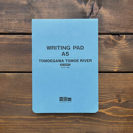The Tomoe River notebook is a thin and light notebook paper. It has excellent writing properties for fountain pens, ballpoint pens, pencils, etc., and the soft paper makes it easy to open the notebook. It attracted attention from Japan and abroad because it was adopted in the "Almost Daily Notebook". In 2019, Tomoegawa Paper Mill stopped paper machine No. 7 at the Shizuoka Plant, which had been producing paper for Tomoe River. Since then, we have switched to No. 9 paper machine.

Size: 148×210mm
Number of s