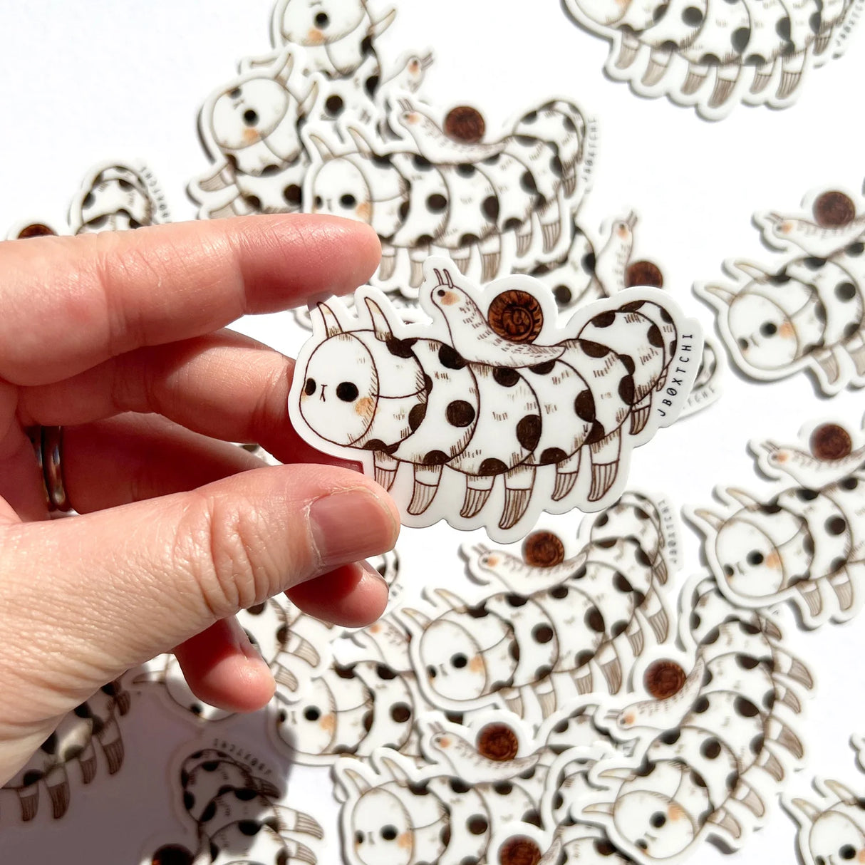 The caterpillar vinyl sticker was illustrated by jb0xtchi (Jessica Ng). jb0xtchi creates stationary and small trinkets from whimsical ideas in the form of painting using ink, watercolour, and gouache.