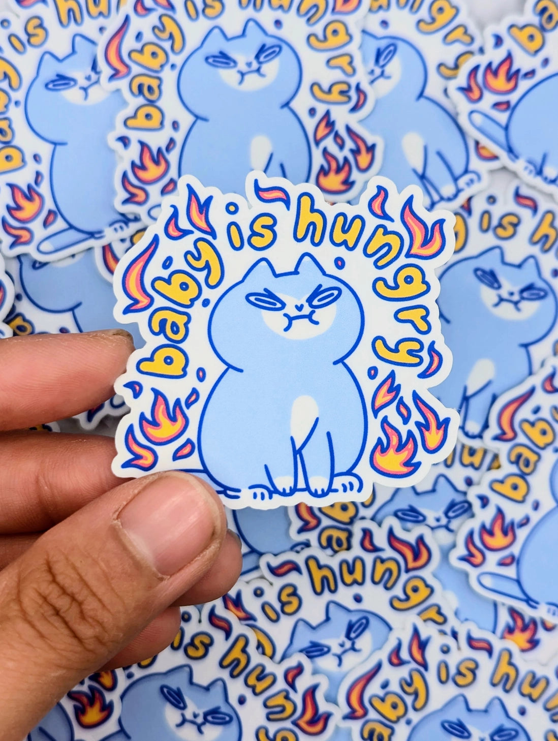 Perfect for those who understand the power of a hangry kitty, this 2" sticker features an adorably angry cat surrounded by vibrant flames. Made from durable, waterproof vinyl, this sticker is built to withstand the elements—whether you stick it on your water bottle, laptop, or anywhere else you want to show off your sassy side. Add a touch of attitude and humor to your collection with this cute yet fiery design!