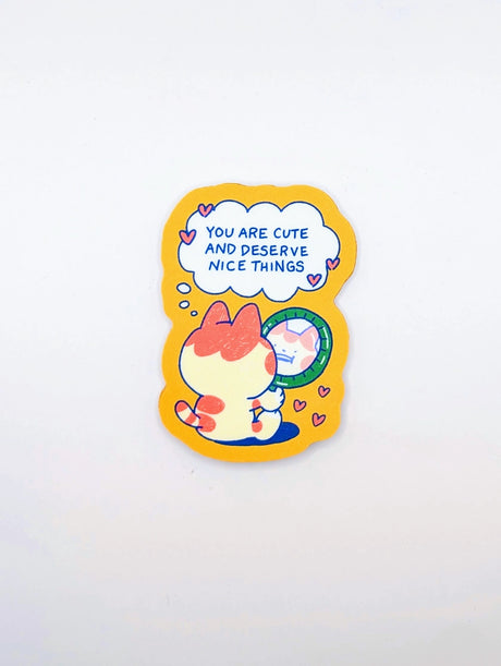 Give yourself (or a friend) a little daily boost with this "You Are Cute and Deserve Nice Things" vinyl sticker! Featuring an adorable chubby cat gazing into a mirror with a sweet self-affirming message, this sticker is the perfect reminder to practice self-love and kindness. The warm, cozy color palette and playful design make it an uplifting addition to your laptop, water bottle, journal, phone case, or anywhere you need a dose of encouragement.