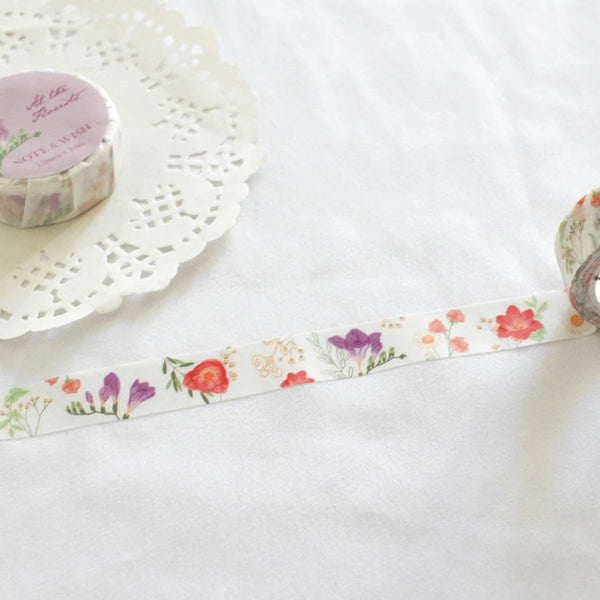 At the Florists   This tape features beautiful hand drawn floral illustrations of purple and pink freesias, peach sweet peas and gypsophila, decorated with leaves. 