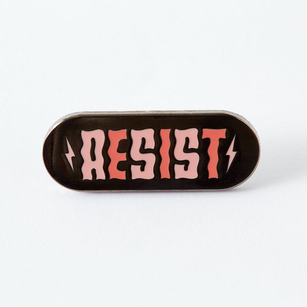 If they think we’re going to take their shit lying down, they can think again. Now is the time to resist. To fight back. To protest. To tell politicians and power trippers where to put their vitriol. And when we are lying down (because we all need a break) we’ll be wearing this pin.